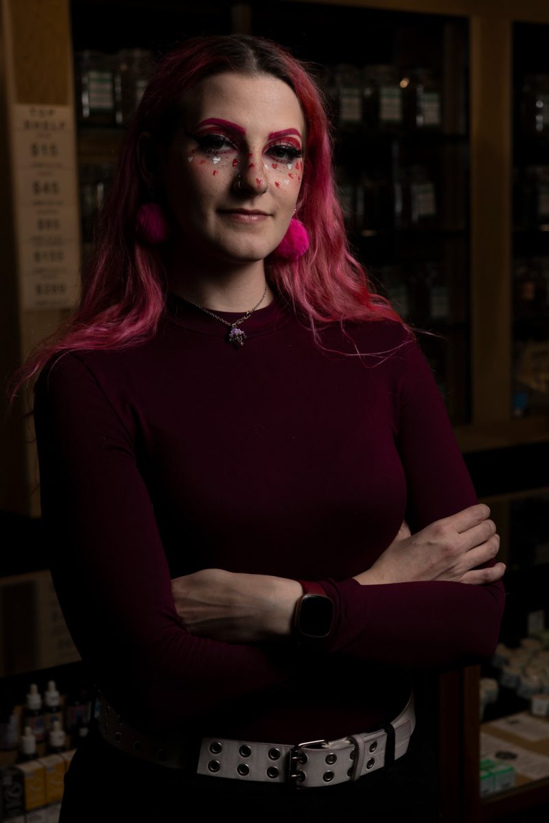 Hannah Youmans, a budtender who has been in the marijuana industry for about two and a half years, poses for a portrait inside TJ’s on Willamette, the dispensary she works at, on Feb. 12, 2024. Originally from New York, Youmans came to Oregon with her younger sister, whom she had custody of, in search of a better situation. “I did not have the best childhood, and I wanted her to have a better childhood,” she said. “She was 14 when we moved here, and that was the end of 2020. Right in the middle of Covid.”