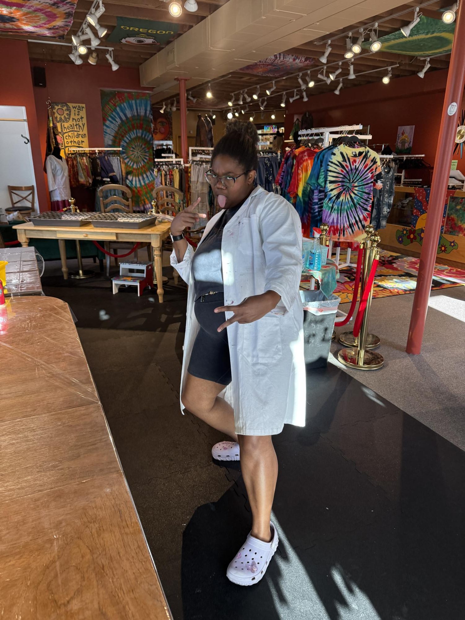 Javay is standing in the Color Lab of the Hippie Closet wearing a white lab coat